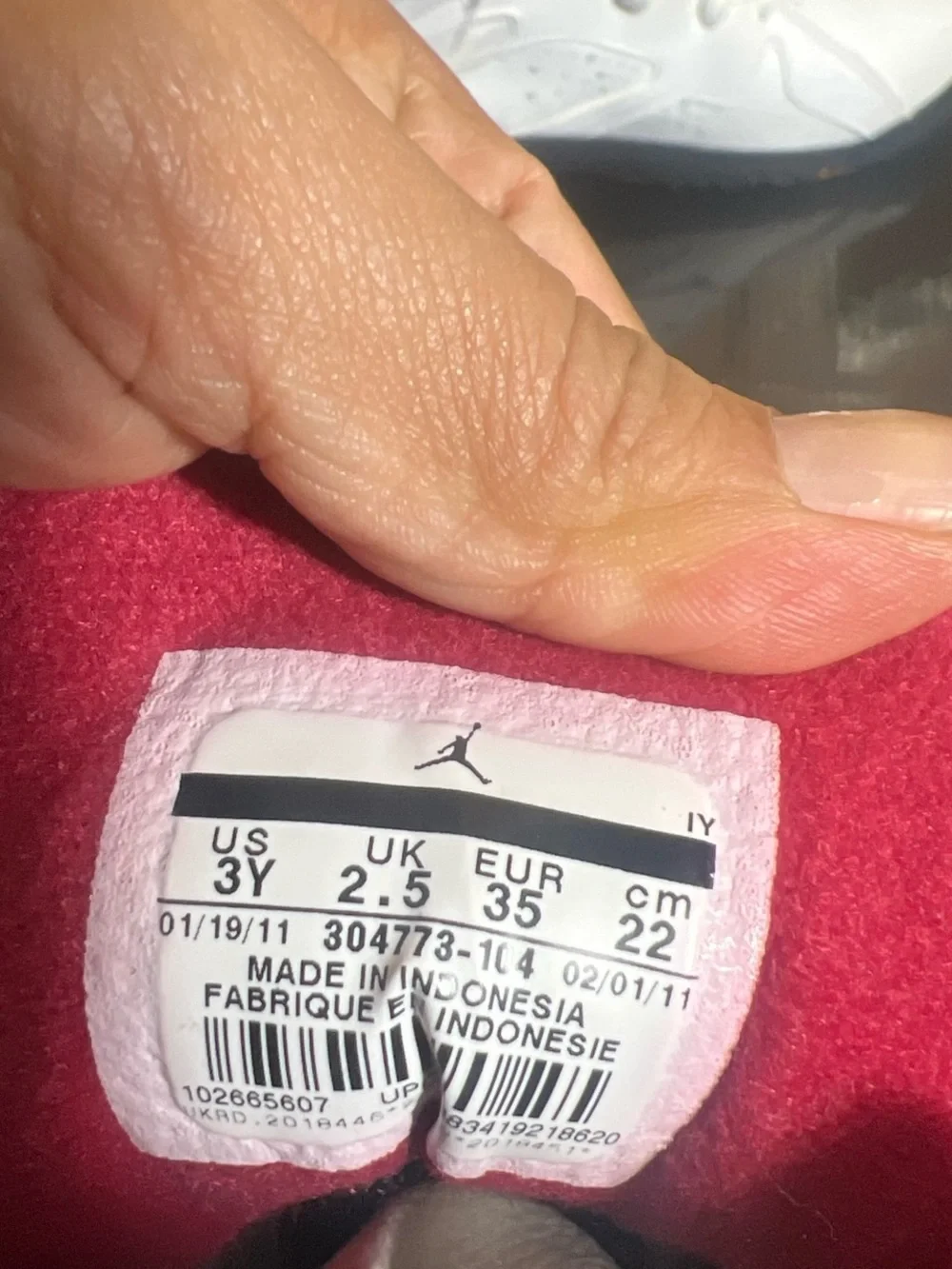 Jordan Kids White High-Top Sneakers with Pink Lining and Yellow Heel Tabs